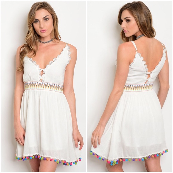 white dress with colorful pom poms